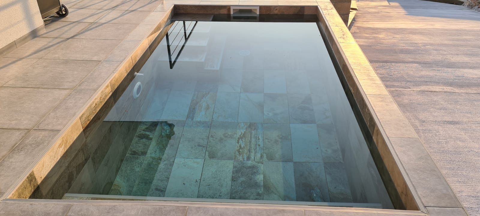 Piscine en béton avec carrelage BALI au coucher de soleil